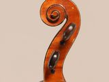an antique violin with a scroll and a bow on a white background