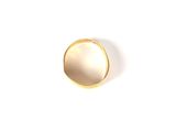a gold ring on a white surface with a white background
