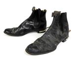 pair of black leather boots on a white surface with a white background