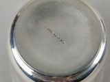 a silver container with a lid on a white surface