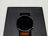 the watch is in a black box on a white surface