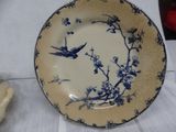 a blue and white plate with a bird on it