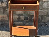 a small wooden table with a drawer on top of it