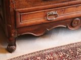 a wooden chest of drawers with a clock on top of it