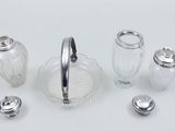 a glass salt and pepper shaker set on a table