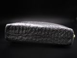 an image of a black purse on a black background