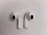 two white airpods sitting side by side on a white surface