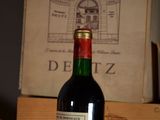 a bottle of wine sitting on a table next to a box of wine