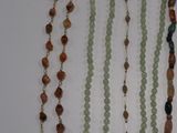 several necklaces of various shapes and sizes are displayed on a table
