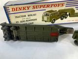 a green toy truck and a box on a table
