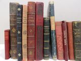 several old books are lined up in a row on a table