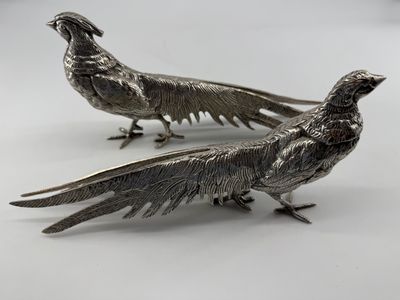 pair of silver plated pheasants on a white background