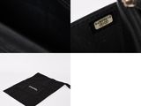 the inside of a black purse with a tag on it and a black bag with a tag on it