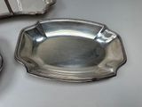 a silver plate and a silver tray on a table