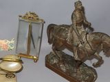 a statue of a man riding a horse next to a mirror