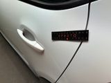 a sticker on the door of a white car