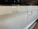 a white car with a sticker on the side of it