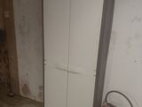a white cabinet with a red fire extinguisor next to it