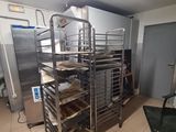 an image of a kitchen with a bunch of trays of food on the floor