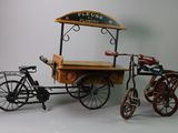 a small cart with a bicycle attached to it