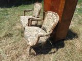 two chairs that are sitting in the grass