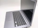 a silver laptop computer sitting on top of a white table
