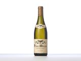 the bottle of white wine is sitting on the table