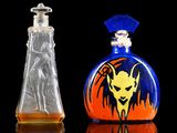 two glass bottles with designs on them sitting next to each other