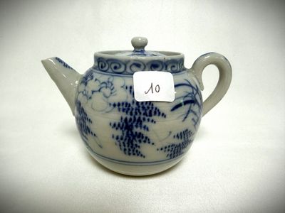 a small blue and white teapot with a tag on it