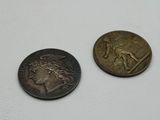 two coins that are sitting next to each other on a table