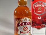 bottles of chivas and a box of cigarettes on a table