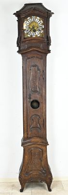 a grandfather clock that is standing in the corner of the room