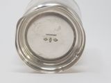 an image of a silver cup with a lid on a white surface