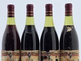 trois bouteilles de vin sont alignées sur une surface blanche