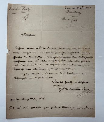 a piece of paper with handwriting on it sitting on top of a table