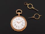 an image of a pocket watch with a key on a black surface