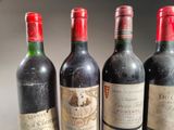 three bottles of red wine are lined up on a table