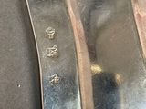 a silver spoon and a silver spoon on a table