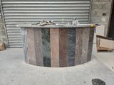 a marble bar on the sidewalk in front of a garage