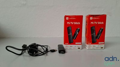 two boxes of wii remotes sitting on a table