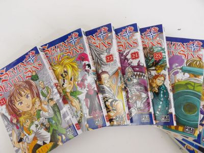 sept livres sur les anime sont alignés sur une surface blanche