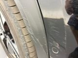 a reflection of a person in a mirror on a car door
