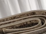 a roll of carpet on the floor next to a curtain