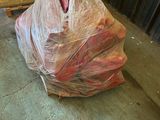 a bag of meat sitting on the floor next to a door
