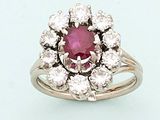 a close up of a ring with a pink stone surrounded by white diamonds
