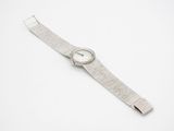 an image of a watch on a white surface with a white background