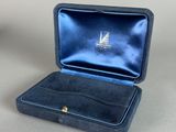 an open box with a sailboat inside of it on a table