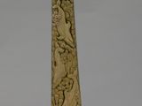 a tall wooden obel with carvings of animals and birds on it