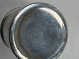 a close up of a metal knob on a white surface