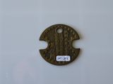 a small metal disc with a picture of a man on it
